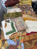 Assorted table clothes, napkins, placemats. Over 50 assorted pieces