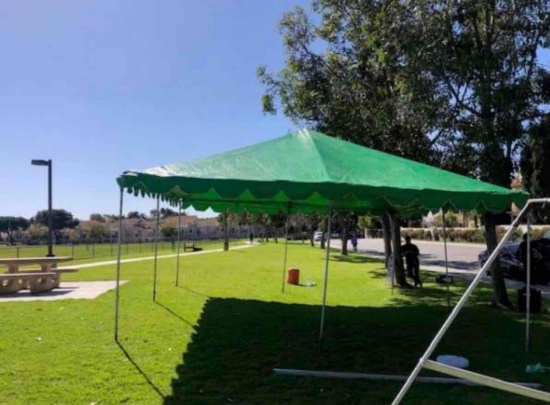 20' x 20' green tent. Includes canopy, poles , fittings, 4 weights & pins