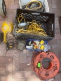 Assorted extension cords, 3 lights ( 2 work), electrical plugs.