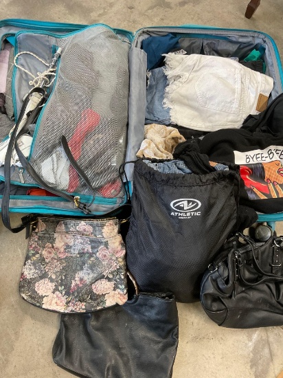 American Tourister luggage and assorted woman's clothing, majority seem to be xs, s