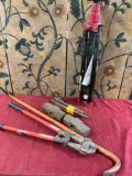 Bolt cutters, Pry bar, Sledge hammer heads, Demo bits, Tro pod, assorted tools / items. 9 pieces