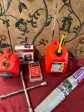 Assorted items. Gasoline containers, tint, clamps, tire inflator wrench. 6 pieces