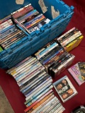 Assorted DVDs and CDs. Over 80 pieces includes storage tub