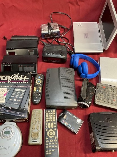 Assorted electronics, remotes, DVD player etc. Electronics with cords turned on. 18 pieces