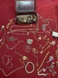 Plastic storage and assorted custom jewelry. Over 50 pieces
