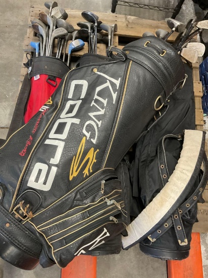 Large lot. Over 40 assorted golf clubs and 4 golf bags