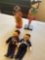 Vintage dolls. Officer, mailman, Hawaian & Oriehral dolls with stands. 4 dolls