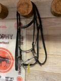 Full cheek snaffle with leather headstall including keepers and English braided reins
