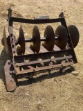 Antique bottom plow, used as yard art.