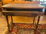 Vintage single drawer table on casters. 29