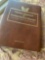 Golden Replica of Unites States stamps album with replicas on a gleaming surface 22kt gold & other