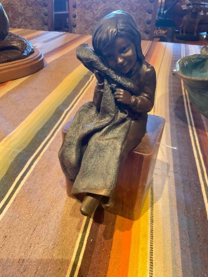 Bronze sculpture of Girl with Blanket by Radtke on wood stand. 10" x 4.5"