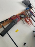 Assorted tools. Complete contents on wall. Work light, saw, rake, blower, electrical cord, etc