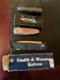 Assorted foldable knives.Smith & Wesson, Wartech USA & unknown. 3 pieces