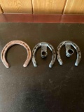 Metal. 2 horseshoe candle holders & horseshoe. 3 pieces