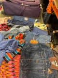 TPRC rolling luggage and assorted clothing. 17 pieces