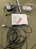 Wii console turned on, Apple TV unit turned on, Nintendo sensor bar, assorted cables