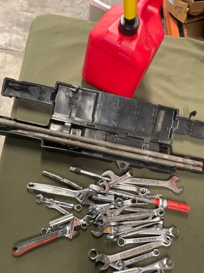 2 gallon gasoline container, GMC incomplete spare tire jack, assorted tools. Over 30 pieces