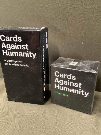 Opened Cards Against Humanity Green box & opened Cards Against Humanity games
