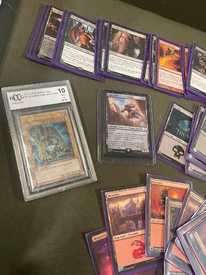 70) Magic cards all with sleeves, 1) Ezio Auditore da Firenze 1) Dark Magician cased cards