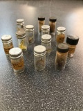 Group of 12 vintage trout flies in containers