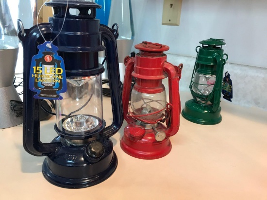 Group of three small metal lanterns, two LED one oil