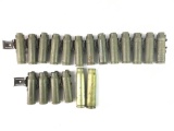 Group of US military 25 mm empty casings with belt