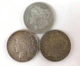 Group of three silver dollars including to Morgan dollars and one peace dollar