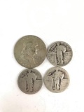 Group of three standing liberty silver quarters and one Franklin silver half dollar