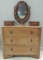 Antique Walnut Three Drawer Dresser with Oval Mirror, Hanging Pulls, and Carved Handles