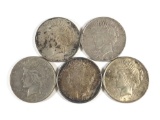 Group of five silver Peace dollars