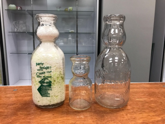 Group of three vintage milk bottles