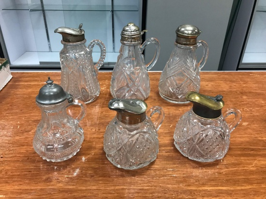 Group of six early American press/cut glass syrups