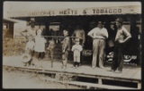 Real Photo Postcard of Grocery Store Front Featuring Children with Catfish