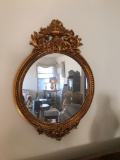 Round mirror with gilded frame