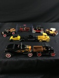 Lot of nine scale model cars and trucks and coin banks