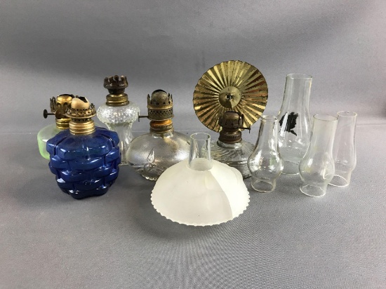 Group of small oil lamp bases and shades