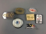 Group of belt buckles, patches and more