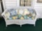 Antique wicker couch with pillows