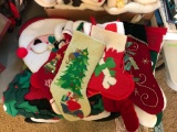 Group of Christmas stockings and quilted Santa