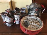Group of enamelware cups, plates, pot