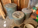 Group of three metal garbage cans with seed