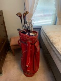 Group of vintage golf clubs with bag and caddy