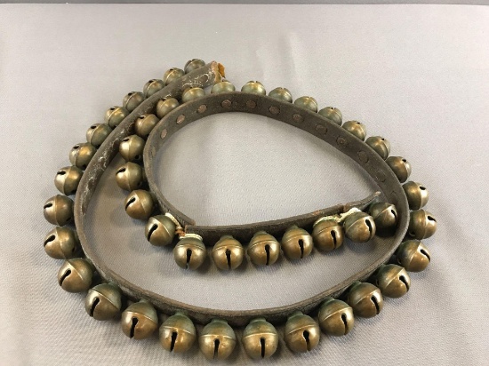 Vintage brass sleigh bells on leather strap