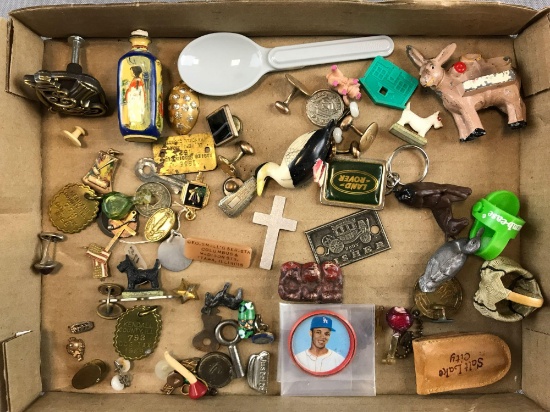 Group of random items including foldable thermos spoon, keychains, animal figures