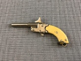 Miniature cap gun/cracker jack gun.