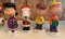 Group of four Peanuts bobble heads