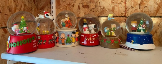 Group of six Peanuts Christmas snow globes