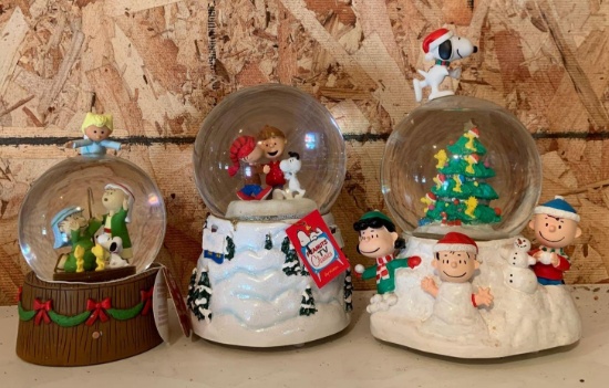 Group of three peanuts Christmas snow globe music boxes