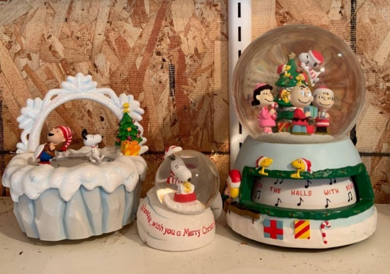 Group of three peanuts Christmas snow globes